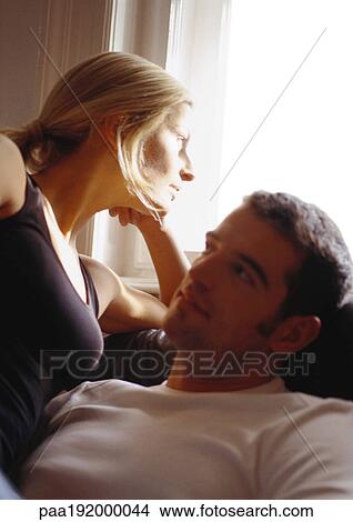 Picture - Woman looking out window, leaning on man, close-up. Fotosearch