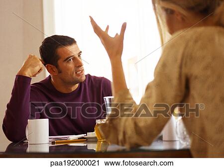 Woman sitting across from man at table, rear view. View Large Photo Image Stock Image - Woman sitting across from man at table, rear view.. Fotosearch