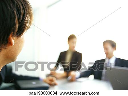 Picture - Business people in a group around table.. Fotosearch