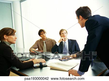 Business people looking at businessman standing. View Large Photo Image Stock Image - Business people looking at businessman standing.. Fotosearch