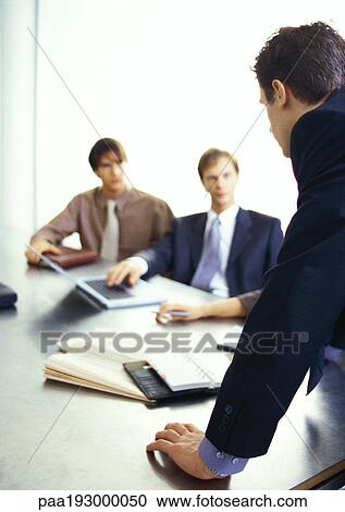 Business people looking at businessman standing. View Large Photo Image Stock Image - Business people looking at businessman standing.. Fotosearch