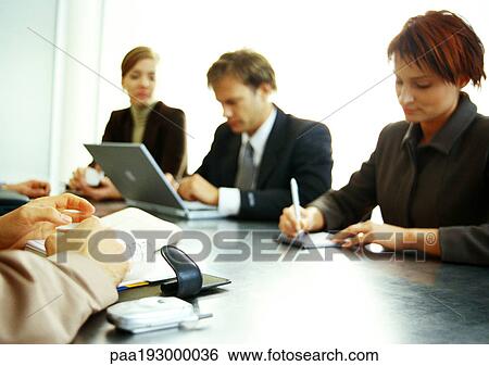 Business people working together at table. View Large Photo Image Stock Photograph - Business people working together at table.. Fotosearch