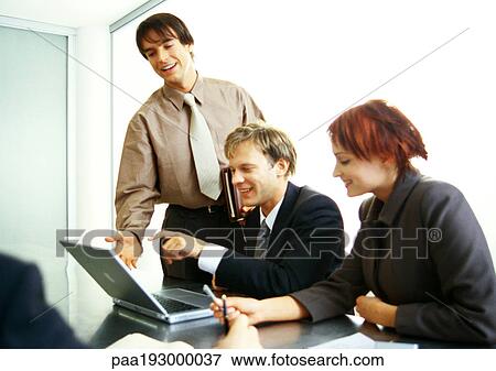 Business people working together on laptop computer. View Large Photo Image Stock Photo - Business people working together on laptop computer.. Fotosearch