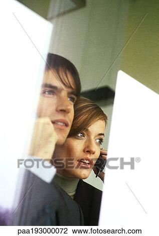 Businessman and businesswoman talking on cell phones, partial view, head and shoulders. View Large Photo Image Stock Image - Businessman and businesswoman talking on cell phones, partial view, head and shoulders.. Fotosearch