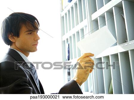 Businessman pulling mail out of slot. View Large Photo Image Stock Image - Businessman pulling mail out of slot.. Fotosearch