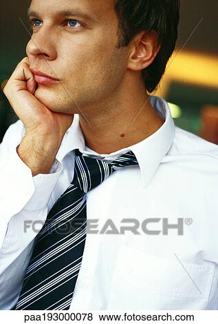 Businessman with hand under chin, portrait. View Large Photo Image Stock Photo - Businessman with hand under chin, portrait.. Fotosearch