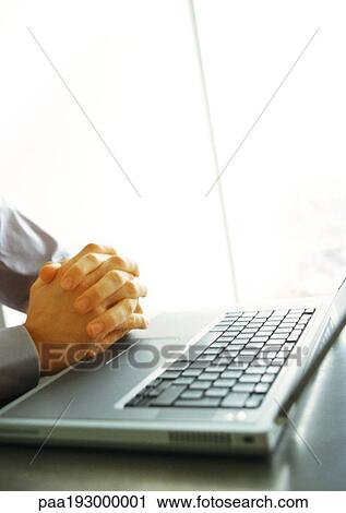 Businessman's folded hands on top of keyboard, close-up View Large Photo Image Stock Image - Businessman's folded hands on top of keyboard, close-up. Fotosearch