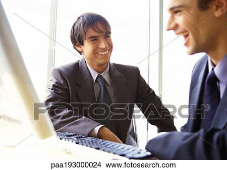 Businessmen laughing together, head and shoulders. View Large Photo Image Picture - Businessmen laughing together, head and shoulders.. Fotosearch