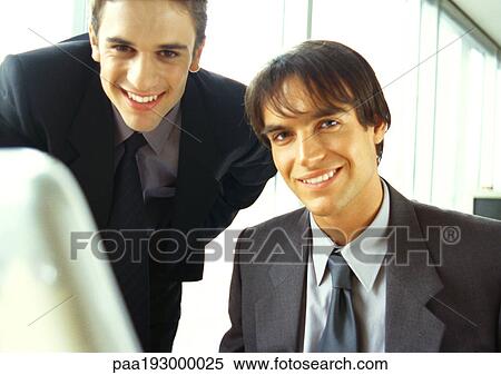 Businessmen smiling at camera, head and shoulders View Large Photo Image Stock Photography - Businessmen smiling at camera, head and shoulders. Fotosearch