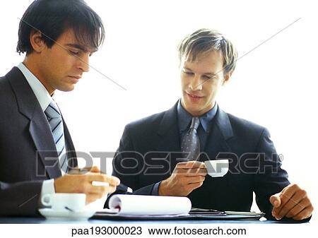 Businessmen working together with coffees View Large Photo Image Stock Image - Businessmen working together with coffees. Fotosearch