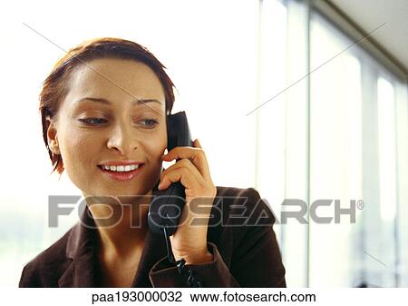 Businesswoman on phone, smiling, head and shoulders, close-up View Large Photo Image Stock Image - Businesswoman on phone, smiling, head and shoulders, close-up. Fotosearch