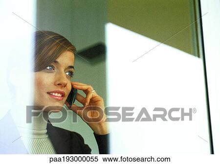Stock Photography - Businesswoman talking on cell phone.. Fotosearch