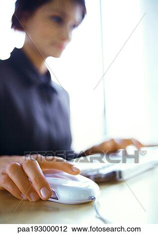 Businesswoman working on computer, blurred, focus on hand on mouse in foreground. View Large Photo Image Stock Image - Businesswoman working on computer, blurred, focus on hand on mouse in foreground.. Fotosearch