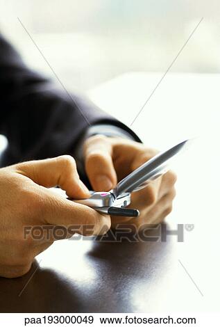 Hands of businessman using cell phone, close-up. View Large Photo Image Stock Photo - Hands of businessman using cell phone, close-up.. Fotosearch