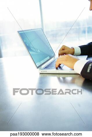 Man using laptop computer, partial view View Large Photo Image Stock Photo - Man using laptop computer, partial view. Fotosearch