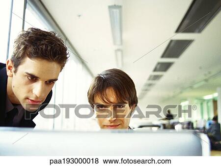 Two men's heads, edge of computer screen in foreground View Large Photo Image Stock Photo - Two men's heads, edge of computer screen in foreground. Fotosearch