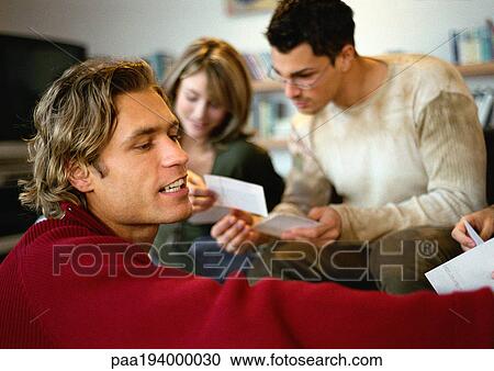 Group of people looking at photos View Large Photo Image Stock Image - Group of people looking at photos. Fotosearch