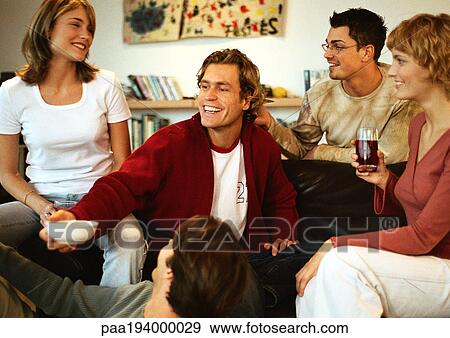 Group of people talking together, man holding out bowl View Large Photo Image Stock Photo - Group of people talking together, man holding out bowl. Fotosearch