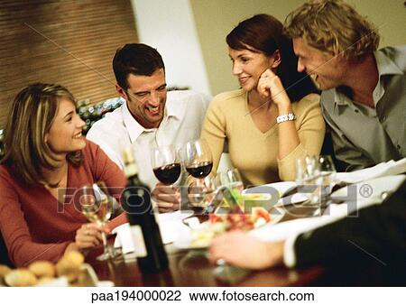 Group of young people around table, drinking wine and laughing View Large Photo Image Stock Image - Group of young people around table, drinking wine and laughing. Fotosearch