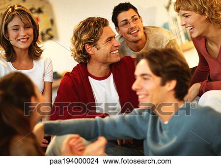 Group of young people sitting together, laughing, close-up. View Large Photo Image Picture - Group of young people sitting together, laughing, close-up.. Fotosearch