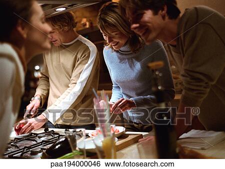 People cooking together in kitchen. View Large Photo Image Stock Photograph - People cooking together in kitchen.. Fotosearch