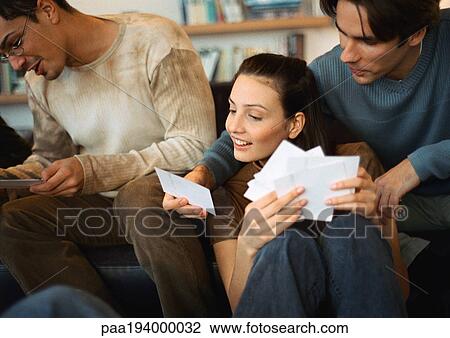 People looking at photos together. View Large Photo Image Stock Image - People looking at photos together.. Fotosearch