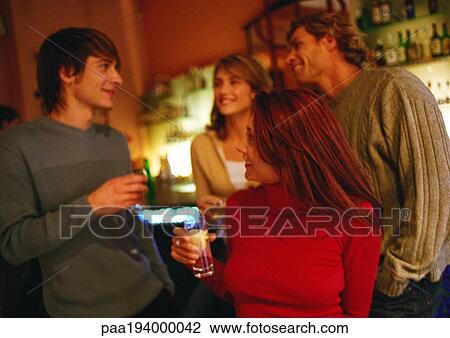 People talking and drinking together in a group. View Large Photo Image Stock Image - People talking and drinking together in a group.. Fotosearch