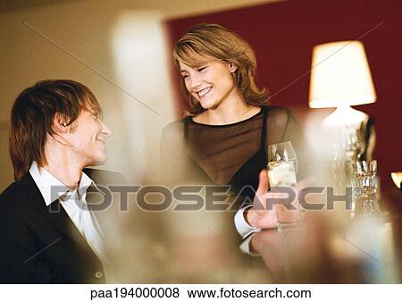 Young man and woman at bar, smiling View Large Photo Image Stock Photo - Young man and woman at bar, smiling. Fotosearch