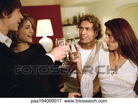 Stock Photo - Young people clinking glasses.. Fotosearch