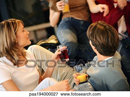 Young people drinking together. View Large Photo Image Stock Photo - Young people drinking together.. Fotosearch