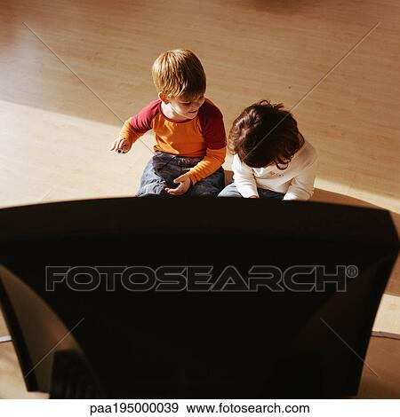 Children sitting on floor together, television in foreground. View Large Photo Image Stock Photo - Children sitting on floor together, television in foreground.. Fotosearch
