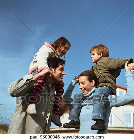 Stock Photograph - Children sitting on parents' shoulders. Fotosearch