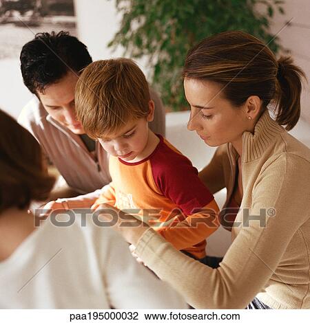 Family sitting together, close-up View Large Photo Image Stock Image - Family sitting together, close-up. Fotosearch