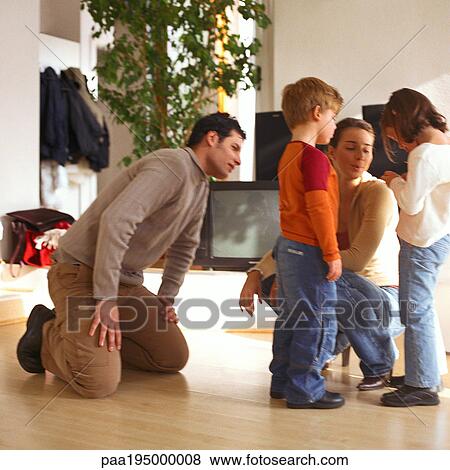 Stock Photo - Father and mother looking at children.. Fotosearch