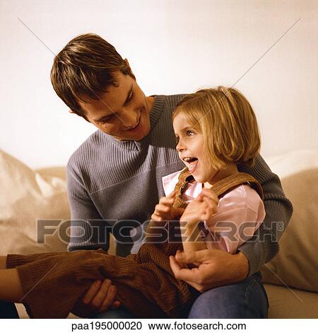 Father holding daughter in lap. View Large Photo Image Stock Image - Father holding daughter in lap.. Fotosearch