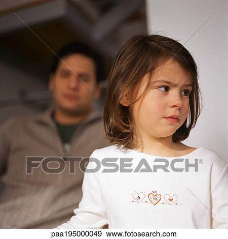 Little girl looking away, head and shoulders, close-up, man in background, blurred. View Large Photo Image Stock Photo - Little girl looking away, head and shoulders, close-up, man in background, blurred.. Fotosearch