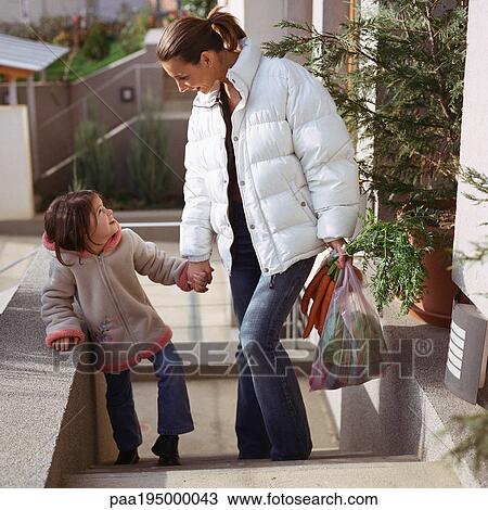 Mother holding daughter's hand, walking up stairs. View Large Photo Image Stock Image - Mother holding daughter's hand, walking up stairs.. Fotosearch