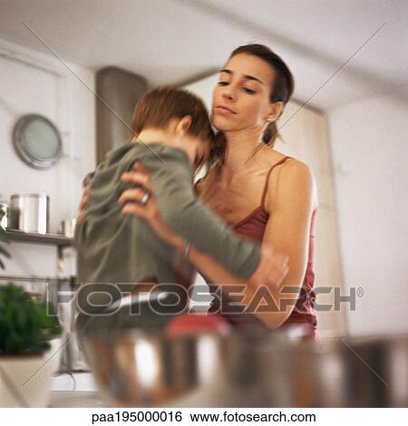 Mother picking up son, waist up, blurred motion View Large Photo Image Stock Photograph - Mother picking up son, waist up, blurred motion. Fotosearch