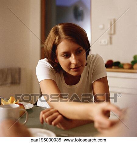 Mother sitting, holding out food View Large Photo Image Stock Photography - Mother sitting, holding out food. Fotosearch