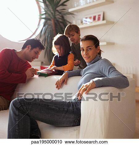 Mother sitting in front of family, playing in background. View Large Photo Image Stock Image - Mother sitting in front of family, playing in background.. Fotosearch