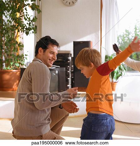 Stock Photograph - Son standing in front of father with arms wide open. Fotosearch