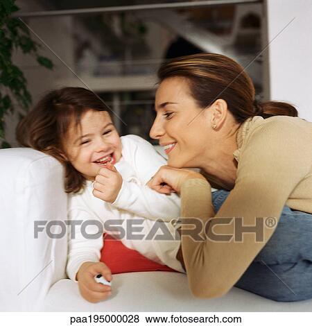 Woman tickling daughter on couch. View Large Photo Image Stock Photo - Woman tickling daughter on couch.. Fotosearch