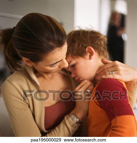 Woman with little boy's head on her shoulder View Large Photo Image Stock Photo - Woman with little boy's head on her shoulder. Fotosearch