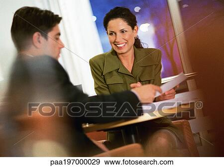 Stock Photo - Businessman and businesswoman working together. . Fotosearch