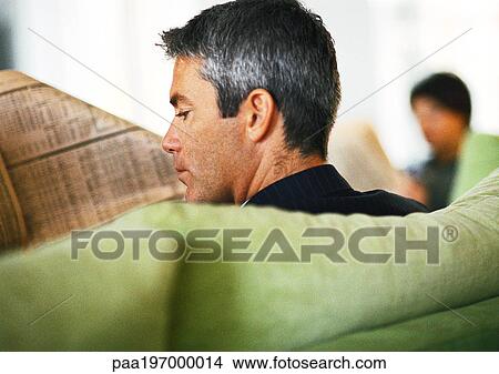 Picture - Businessman reading newspaper, rear view, close-up. Fotosearch