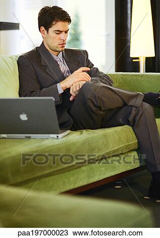 Businessman sitting, checking watch. View Large Photo Image Stock Image - Businessman sitting, checking watch.. Fotosearch