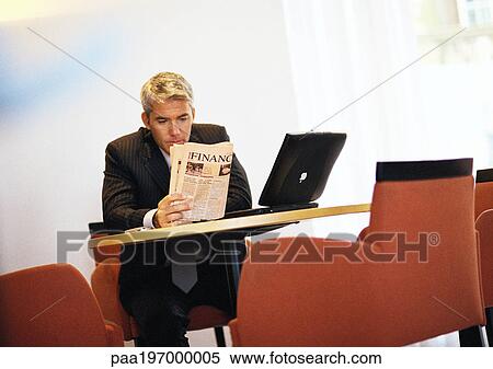 Businessman sitting reading paper. View Large Photo Image Stock Photography - Businessman sitting reading paper.. Fotosearch