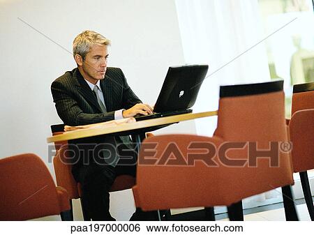 Stock Photograph - Businessman working on computer.. Fotosearch