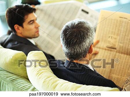 Businessmen sitting reading newspapers, rear view, head and shoulders. View Large Photo Image Stock Photo - Businessmen sitting reading newspapers, rear view, head and shoulders.. Fotosearch