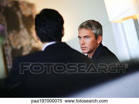 Stock Photography - Businessmen sitting together. Fotosearch